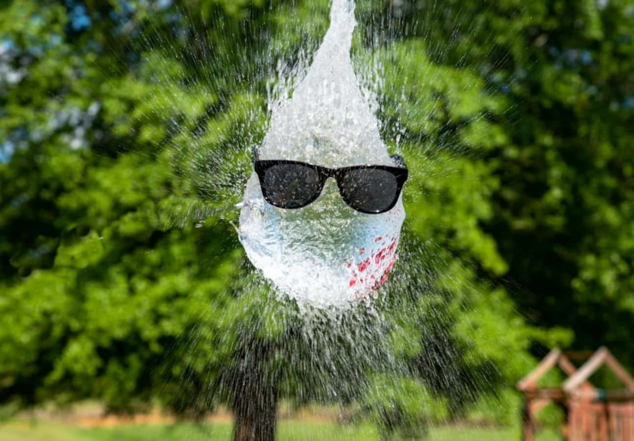 A Pair Of Sunglasses Being Sprayed With Water