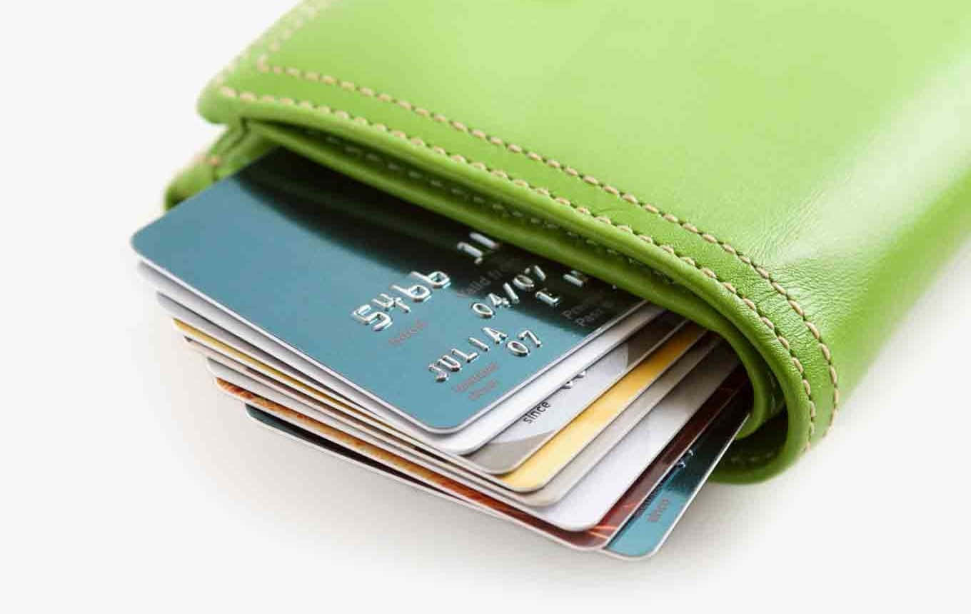 A Green Wallet With Several Credit Cards Inside
