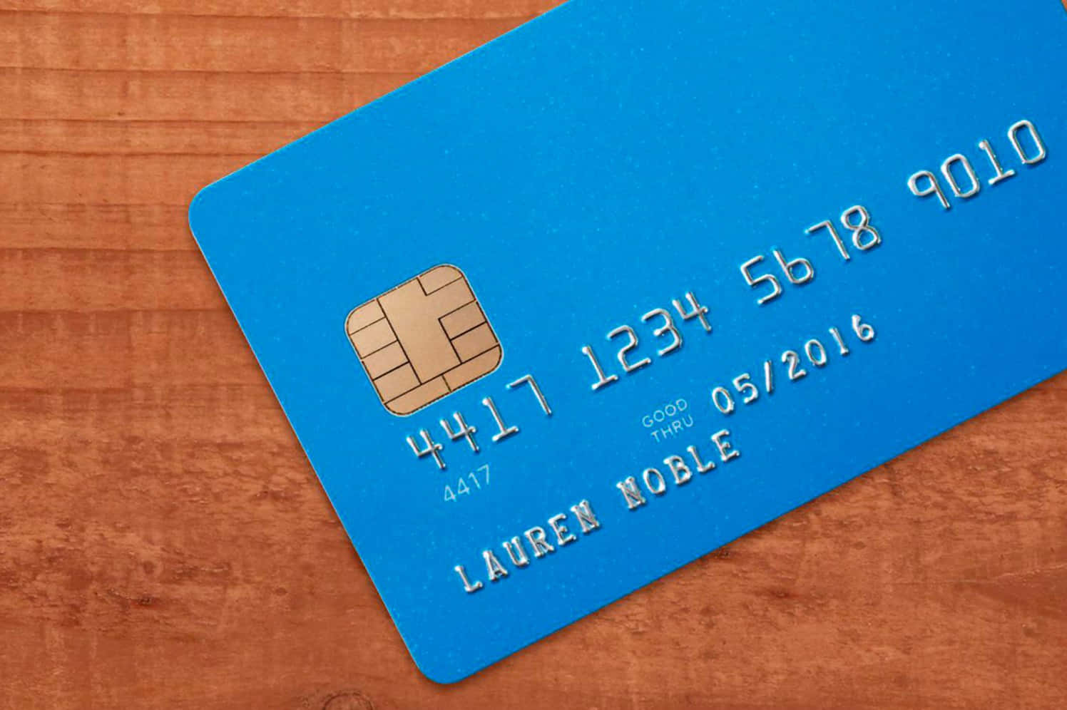 A Blue Credit Card On A Wooden Surface