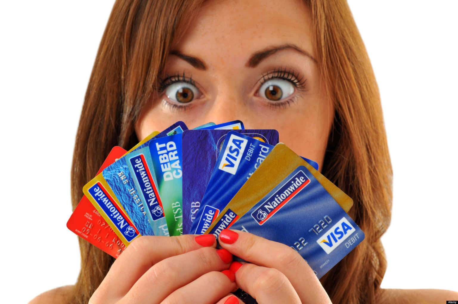 A Woman Holding Up A Bunch Of Credit Cards
