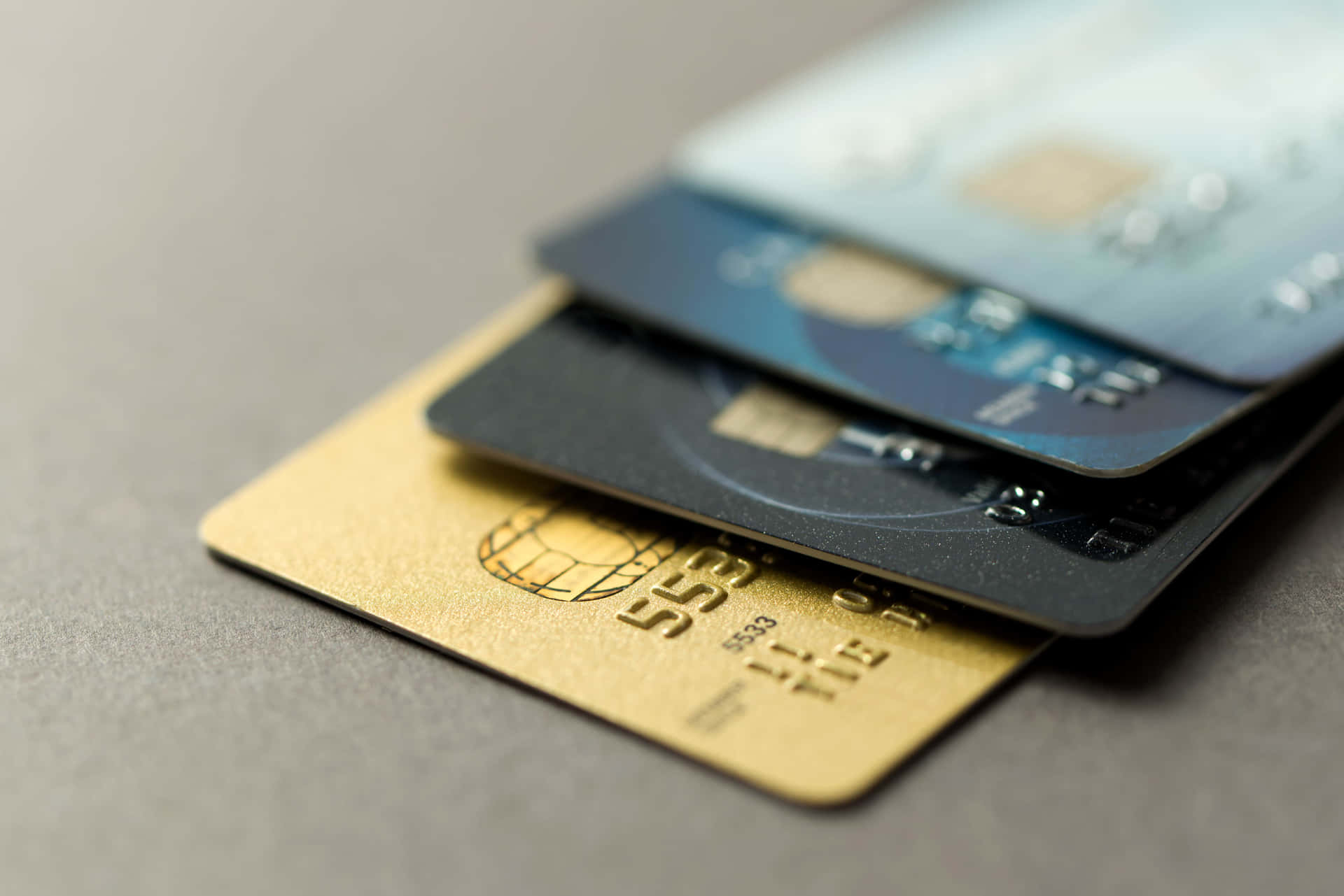 A Group Of Credit Cards On A Grey Surface
