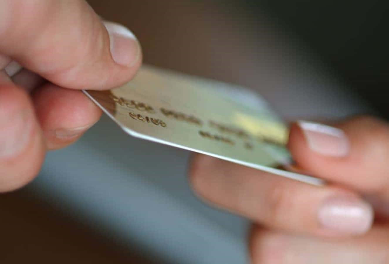 A Person Holding A Credit Card
