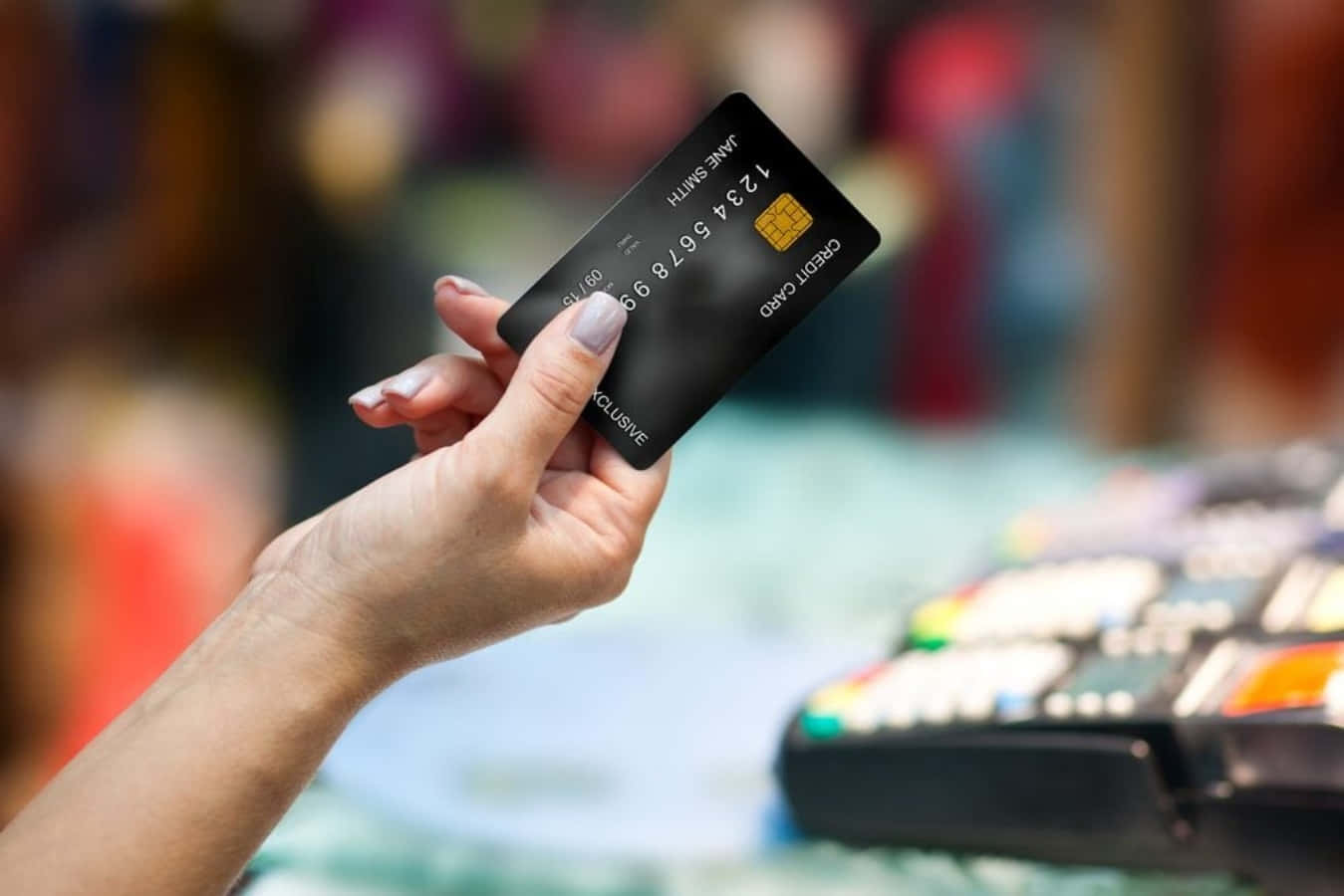 A Woman Is Holding A Credit Card In A Store
