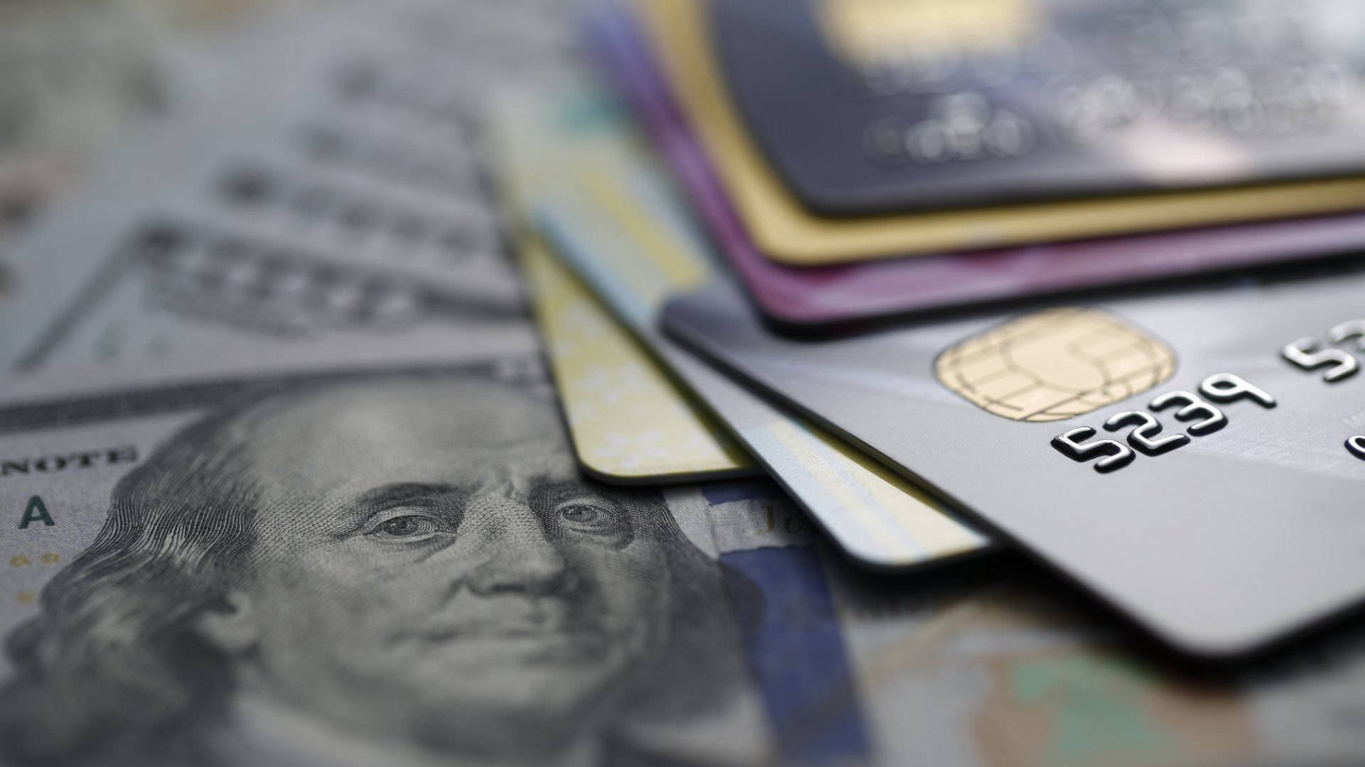 Pile of Credit Cards on Dollar Bills Wallpaper