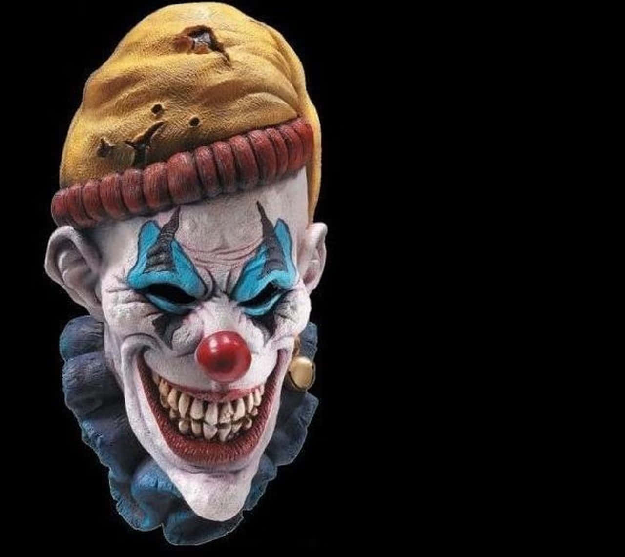 A Clown Mask With A Red Hat And Blue Eyes