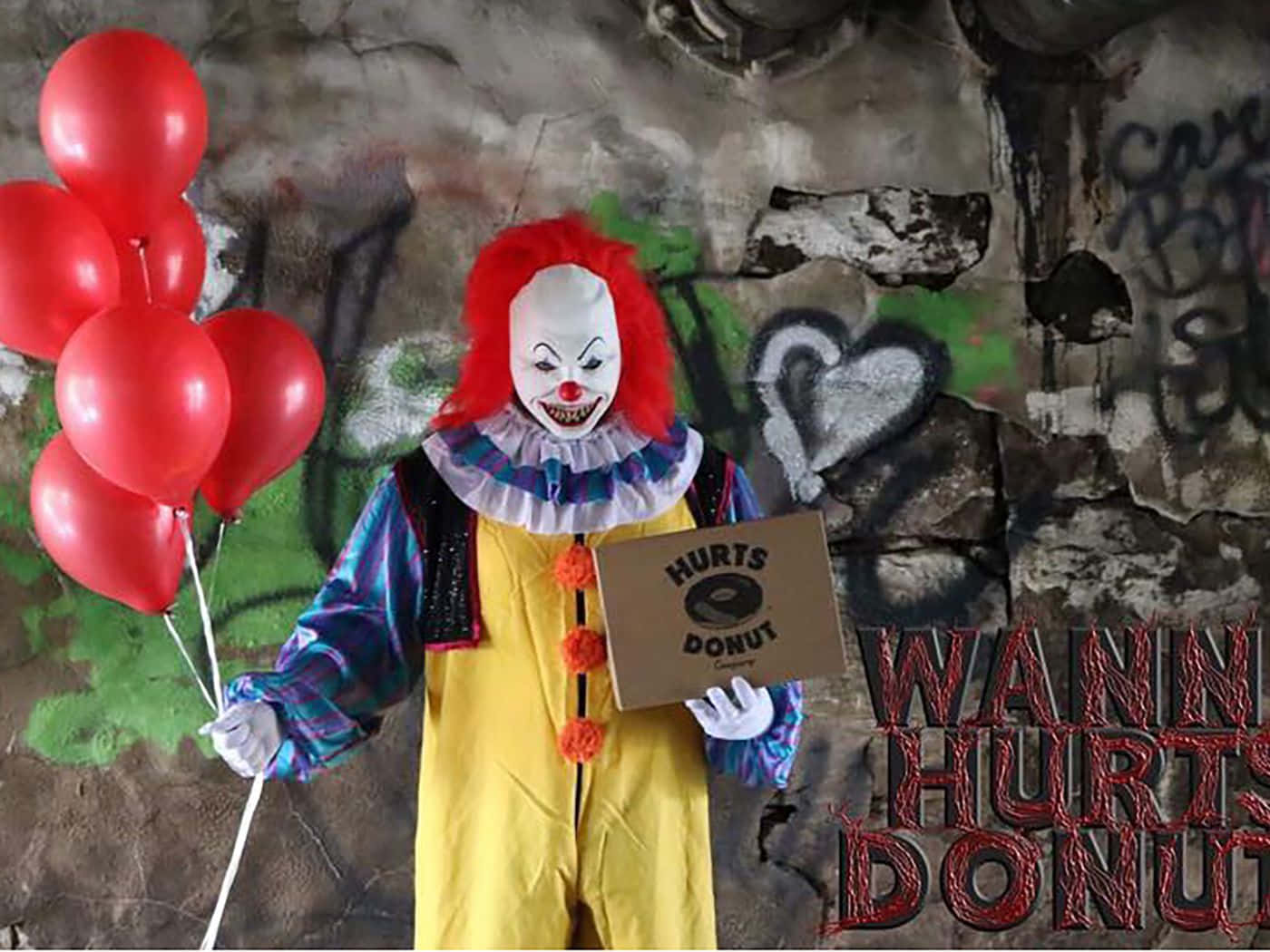 a clown holding balloons and a sign that says wanna hurt donuts