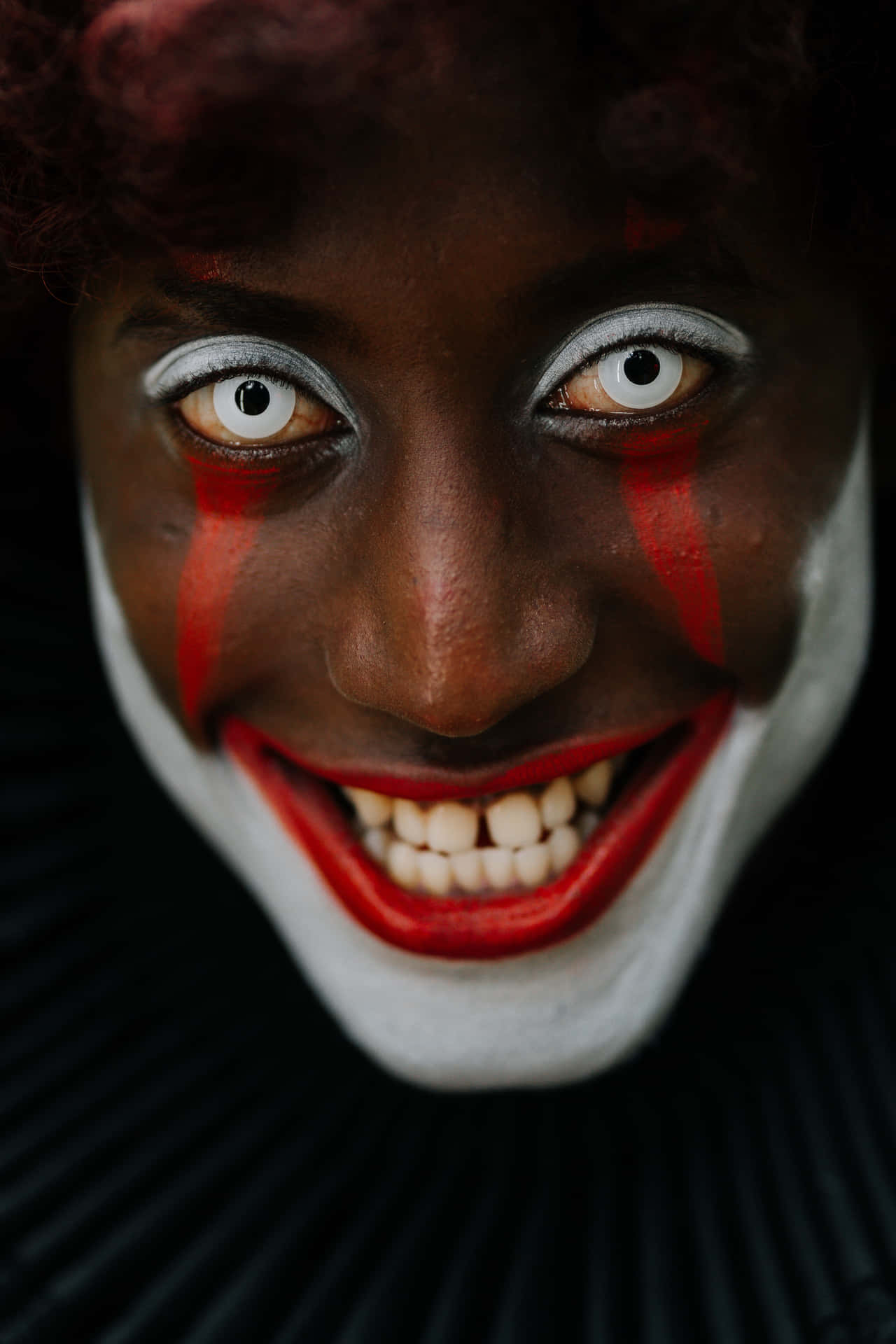 a clown with red and white makeup