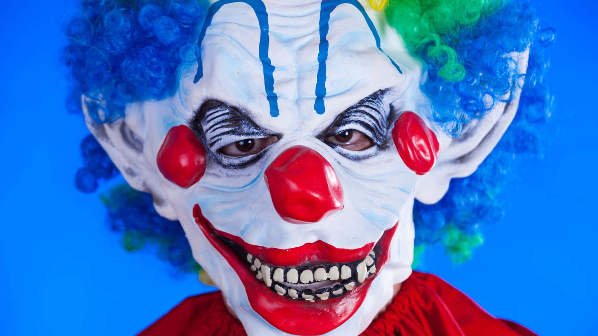 clown mask with colorful hair and red nose