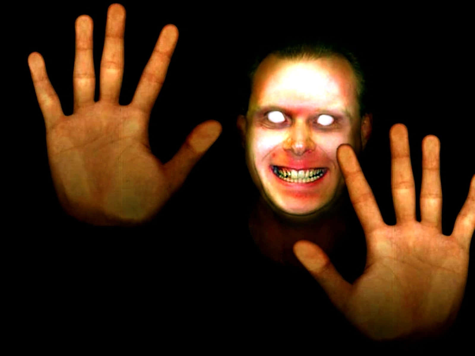 Creepy_ Smiling_ Face_and_ Hands Wallpaper