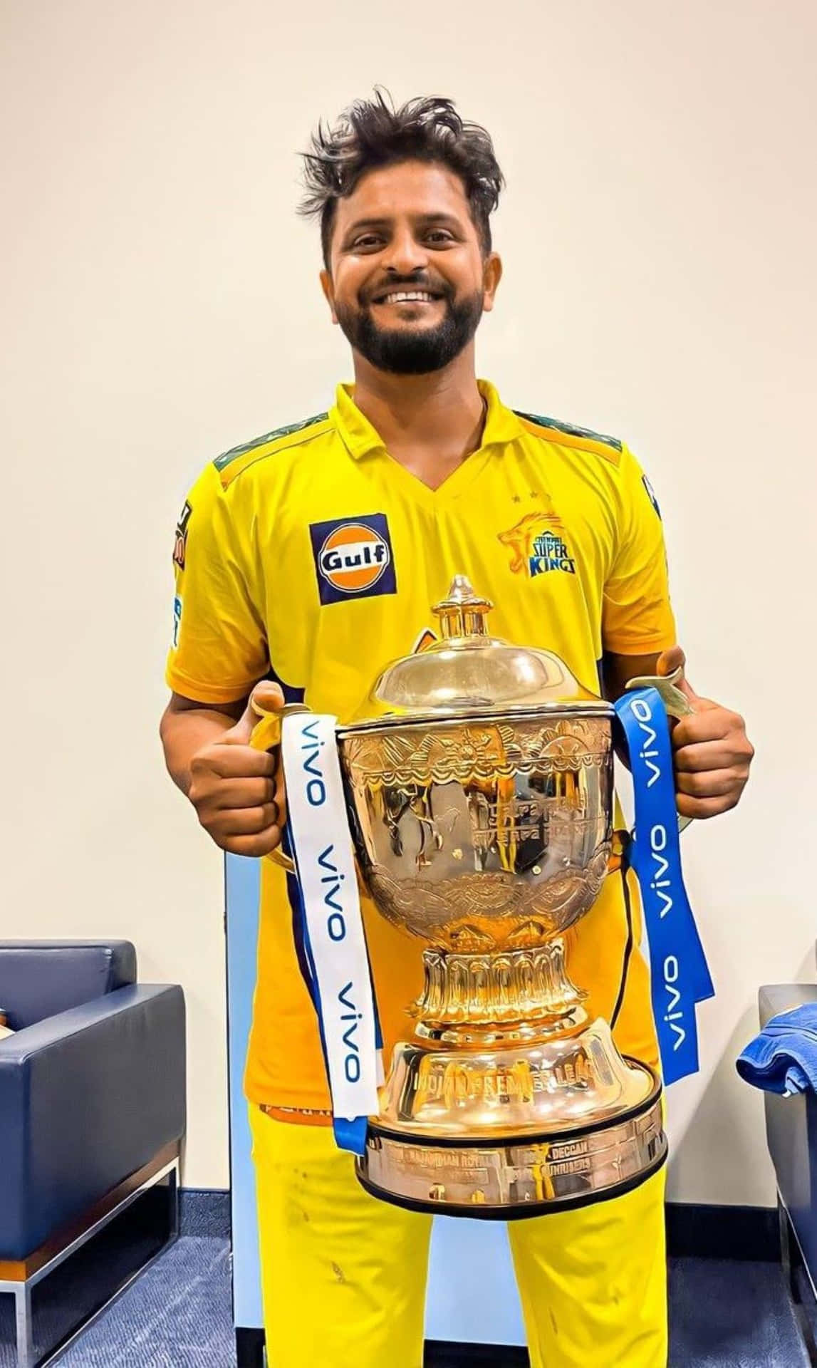 Cricketerwith Trophyin Yellow Jersey Wallpaper