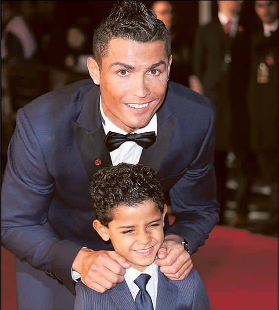 Cristiano Ronaldo Smiling With Child At Event PNG