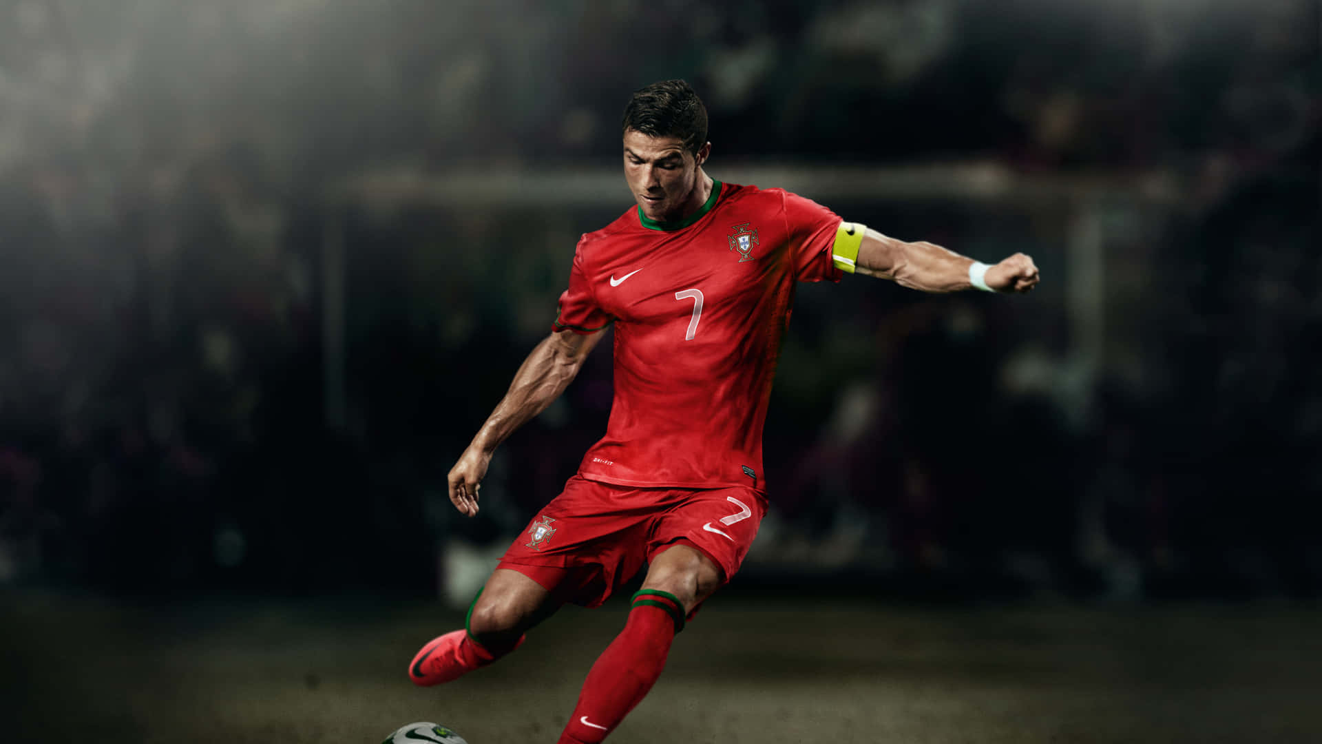 Cristiano Ronaldo scoring a goal while competing in the world's most beloved sport. Wallpaper