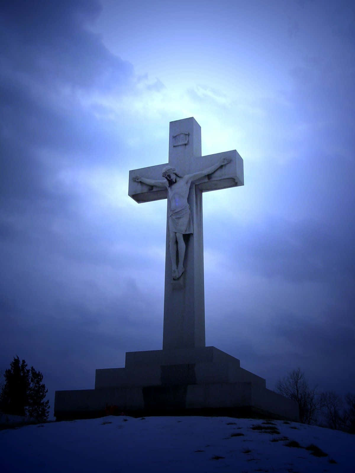 A Jesus Cross Is On Top Of A Hill With A Blue Sky Wallpaper