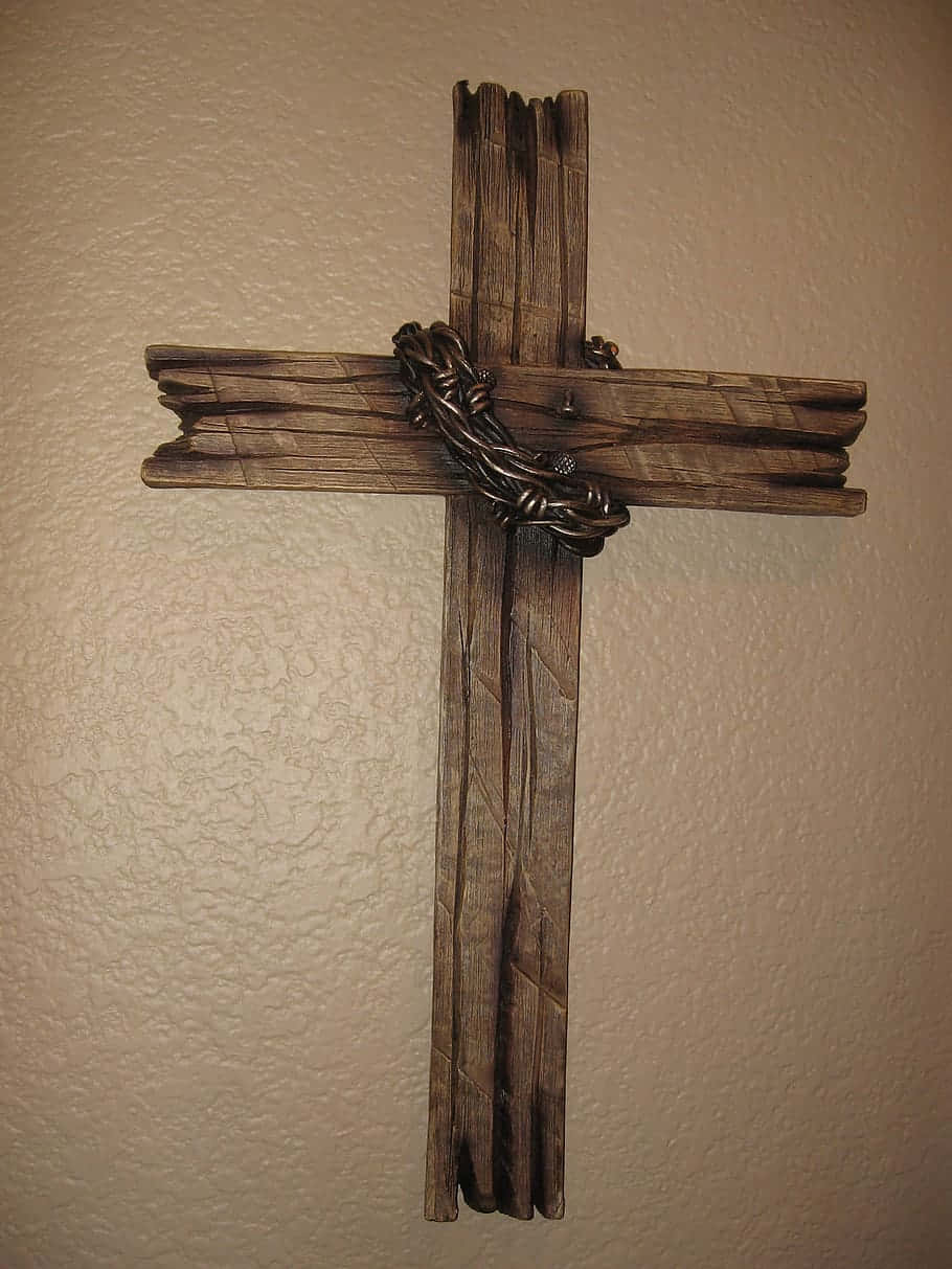 A Wooden Cross With A Chain Hanging On It Wallpaper
