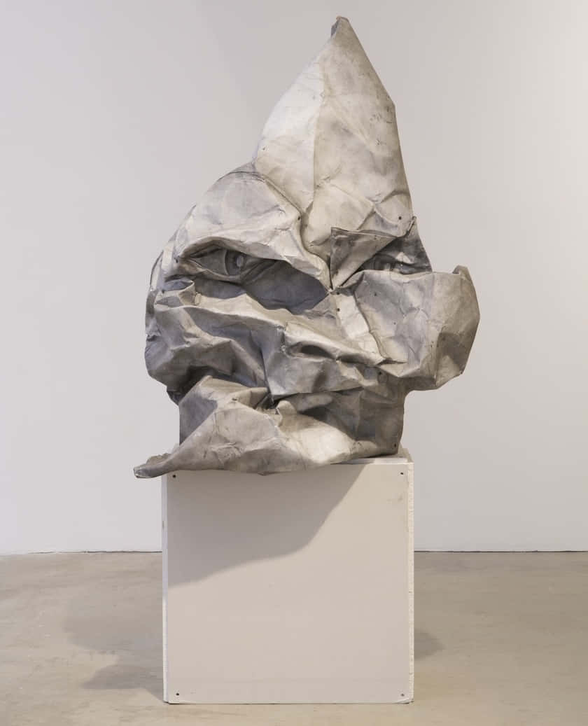 A Sculpture Made Of Paper On A Pedestal