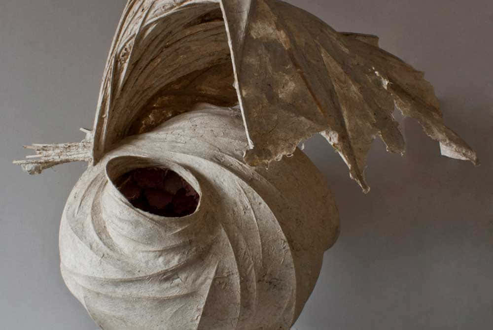 A Sculpture Made Of Paper With A Leaf On It