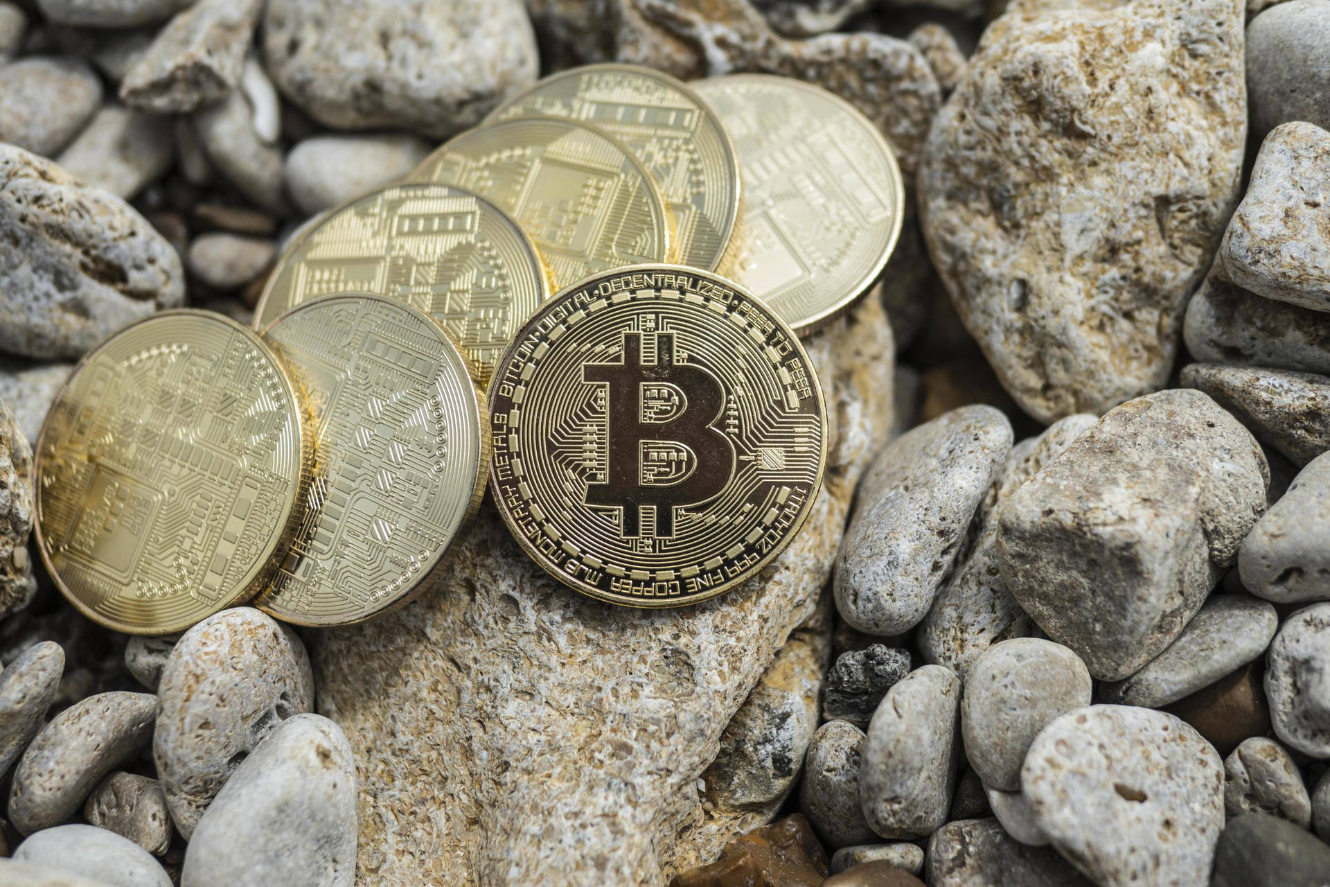 Cryptocurrency Coins On Rocks Background