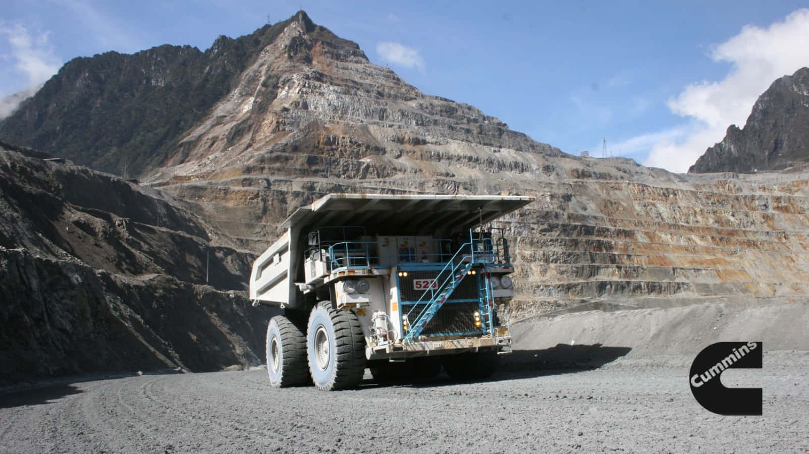 A Large Truck Driving Through A Mine Wallpaper