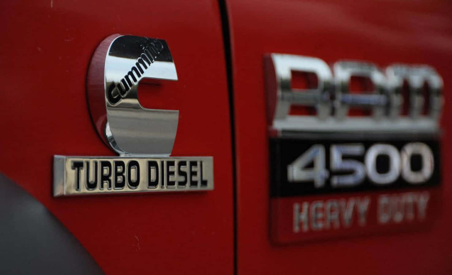 Download A Red Truck With A Logo That Says Turbo Diesel Wallpaper