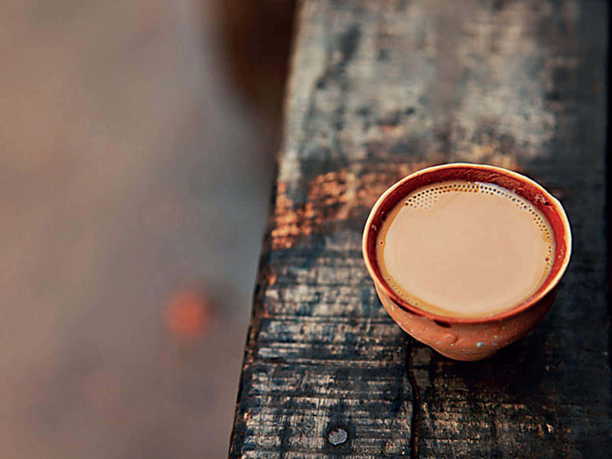 Cup Of Traditional Indian Chai On Wooden Board Wallpaper