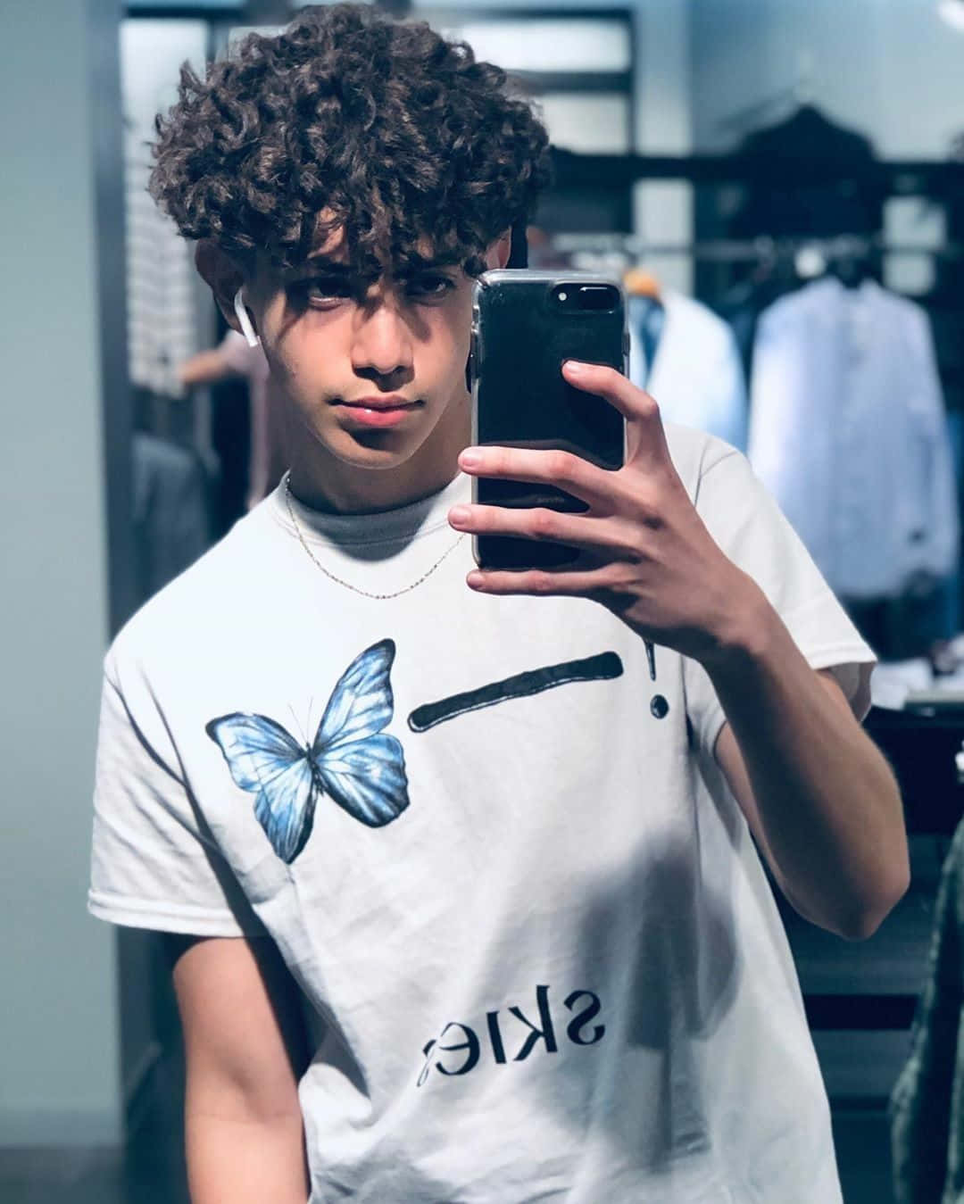 Curly Haired Boy Taking Selfie Wallpaper