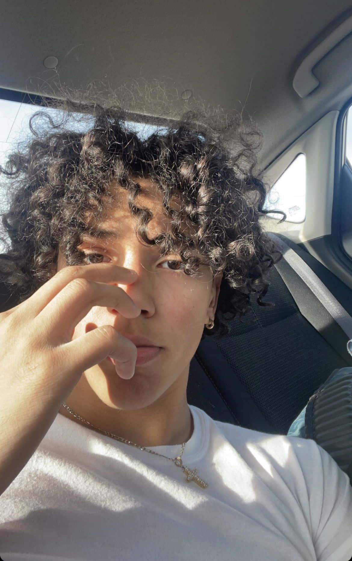 Curly Haired Boyin Car Sunlight Wallpaper