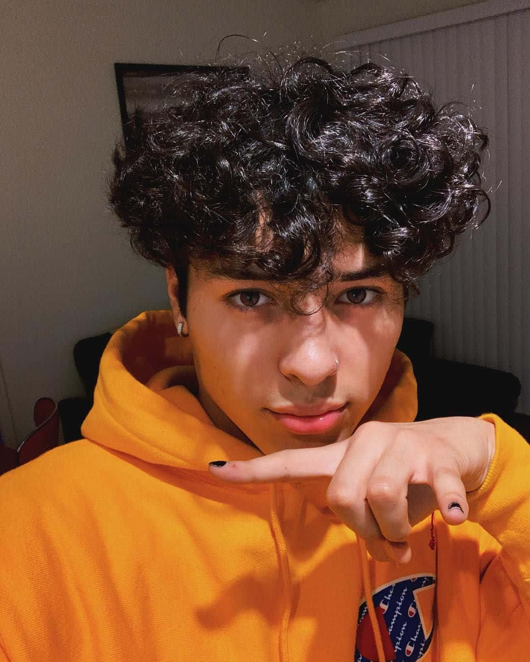 Curly Haired Boyin Orange Hoodie Wallpaper
