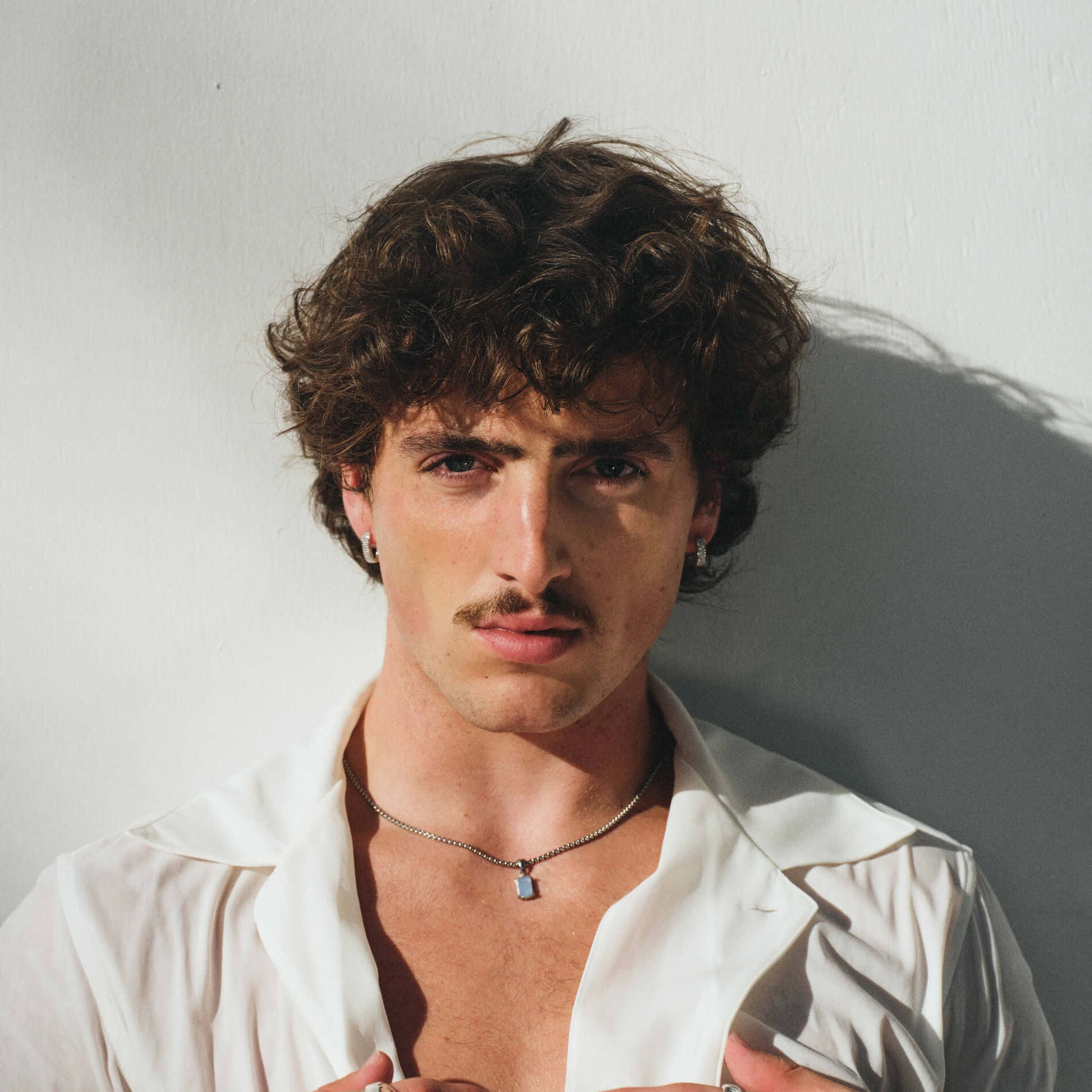 Curly Haired Man In White Shirt Wallpaper