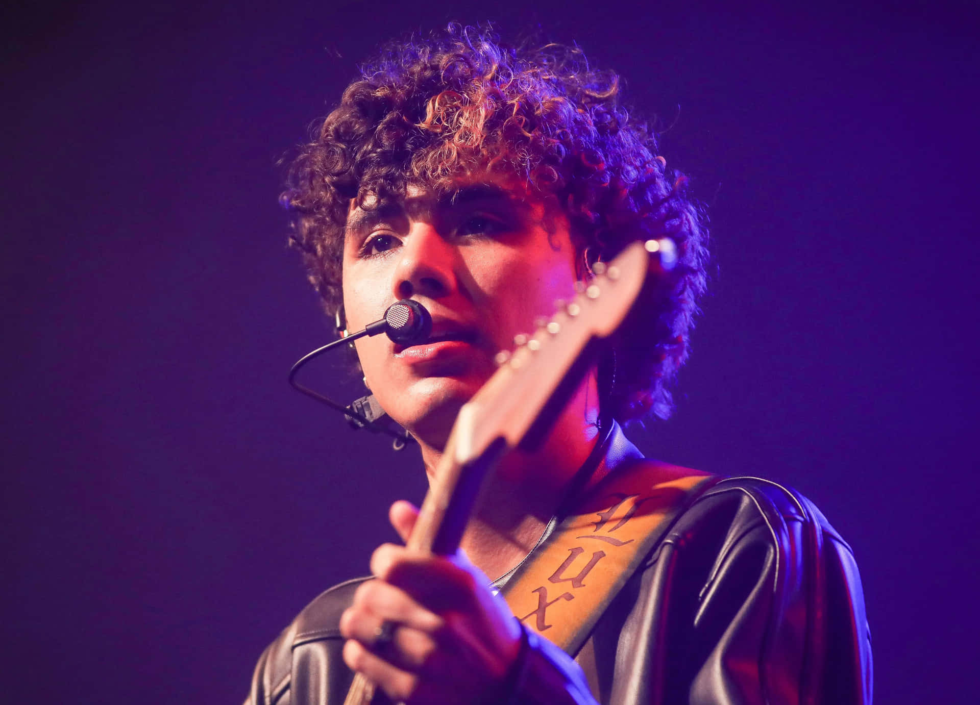 Curly Haired Musician Performing Live Wallpaper