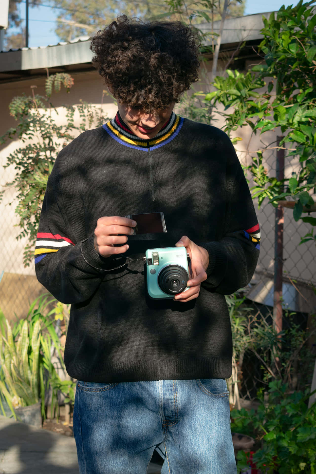 Curly Haired Photographer Checking Instant Photo Wallpaper