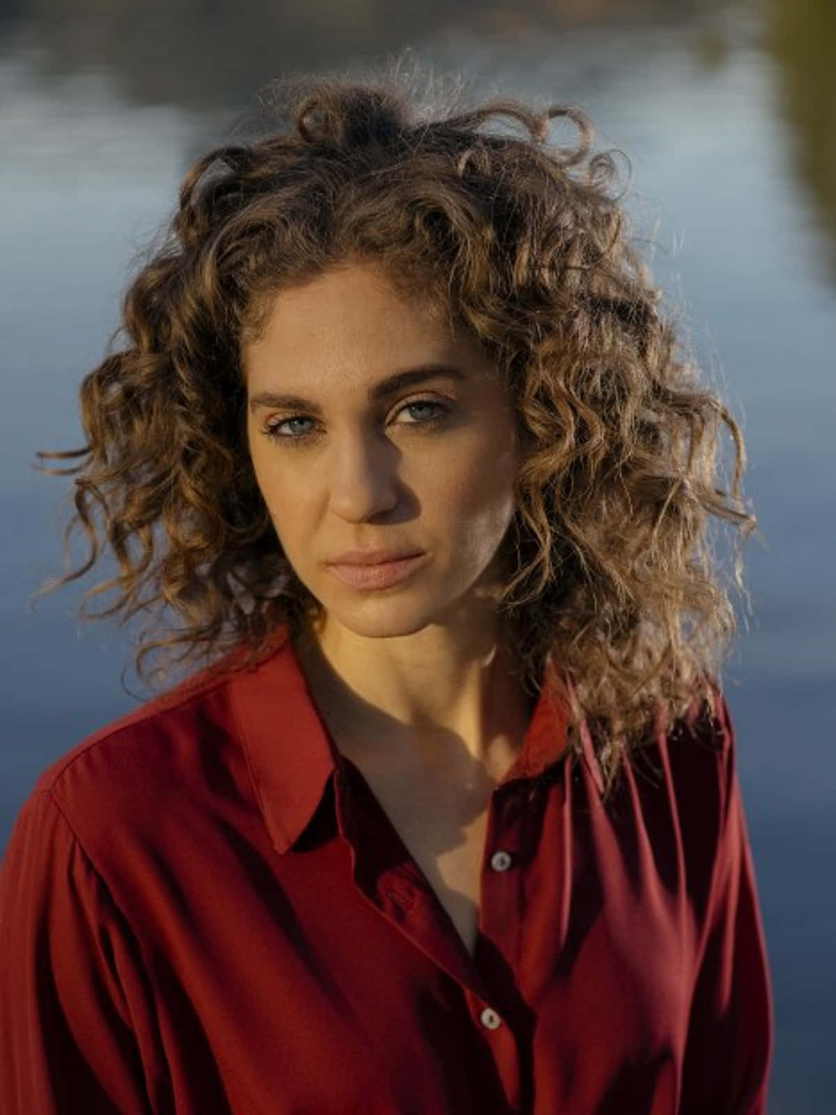 Curly Haired Womanin Red Shirt Wallpaper