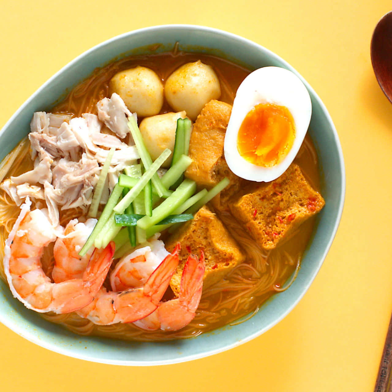 Curry Laksa On Yellow Table Picture