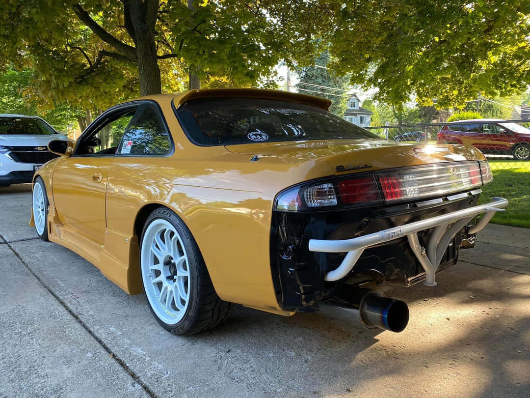 Customized Yellow Nissan240sx Parked Outdoors Wallpaper