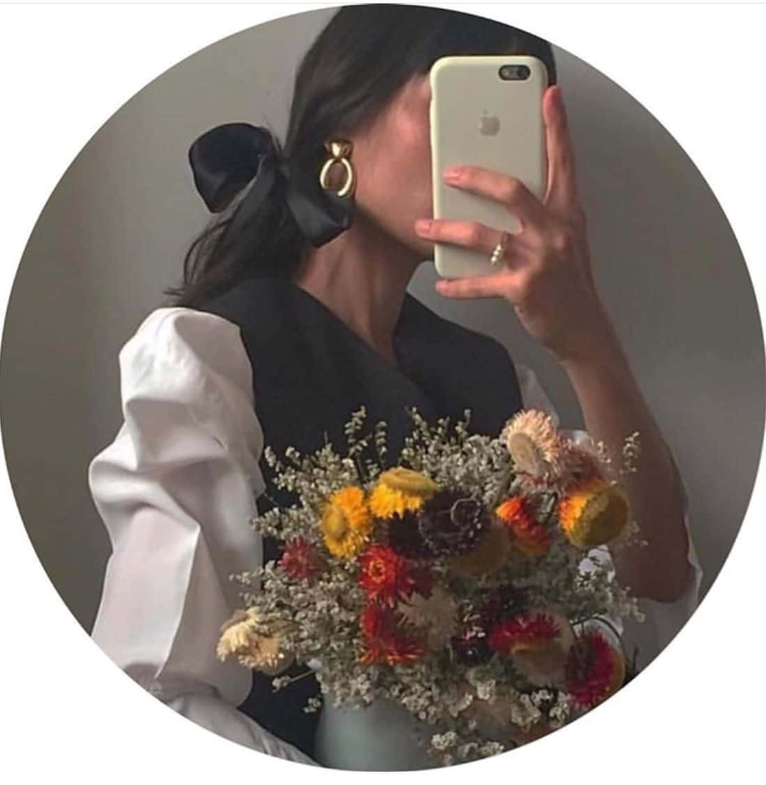 A Woman Taking A Selfie With A Bouquet Of Flowers