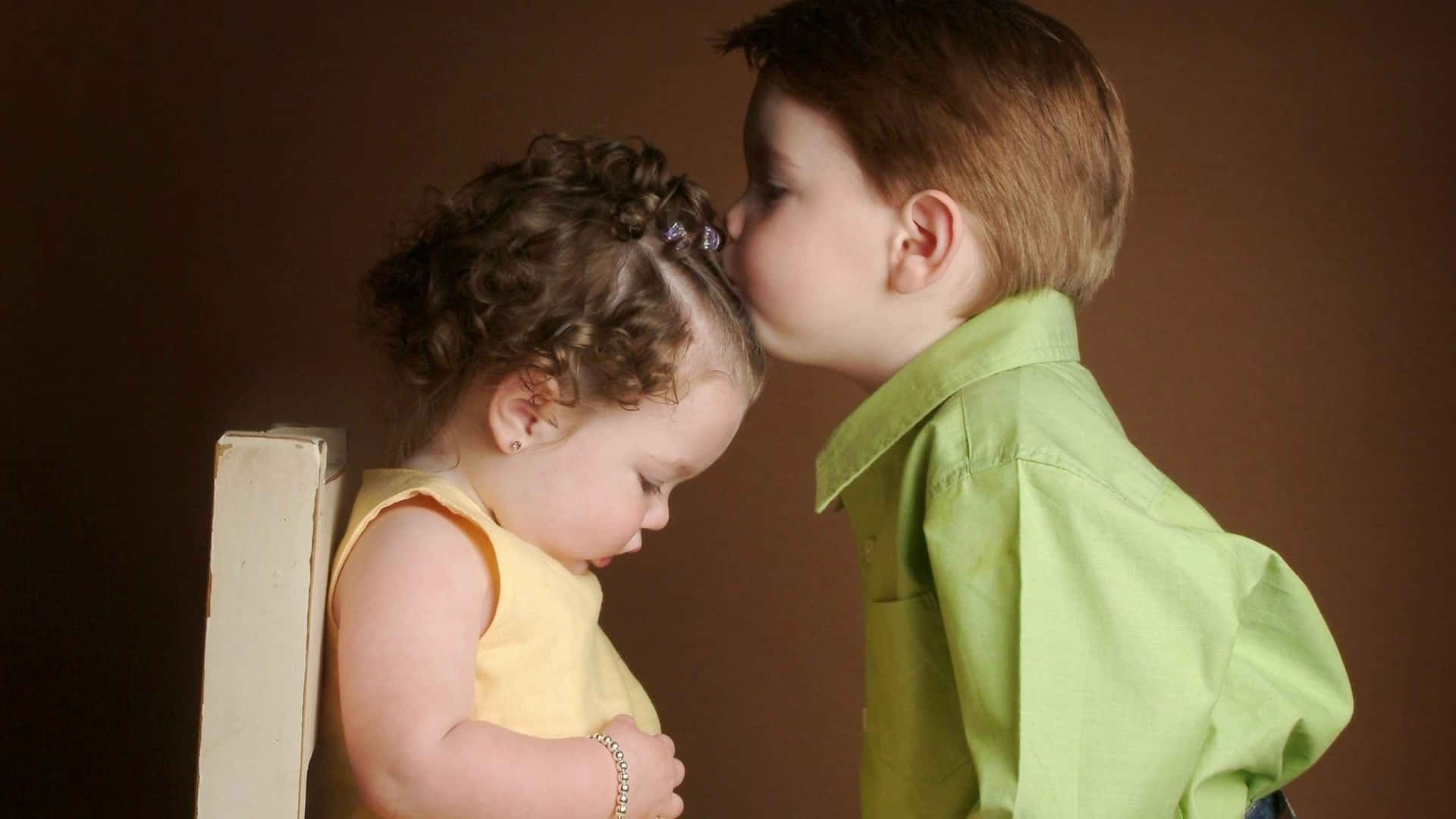 "Innocent Sweetness: A Cute Baby Couple's Foremost Kiss" Wallpaper
