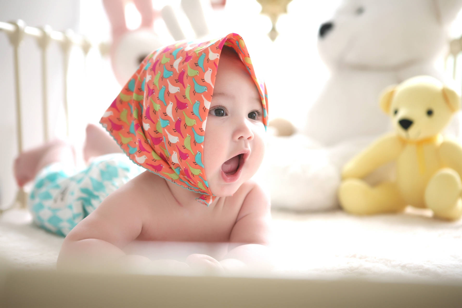 Cute Baby In Crib With Bandana Wallpaper