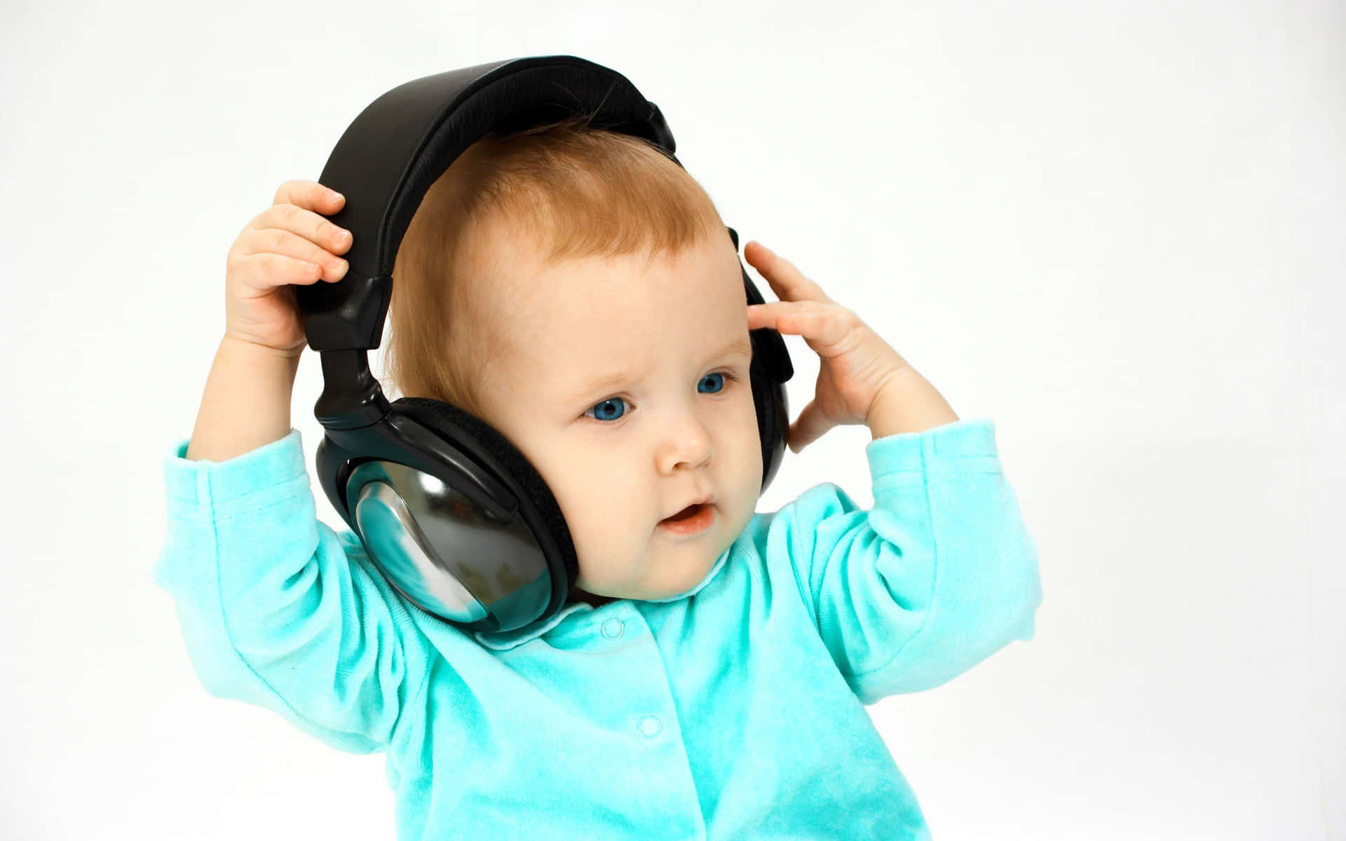 A Baby Wearing Headphones And Holding His Head Up