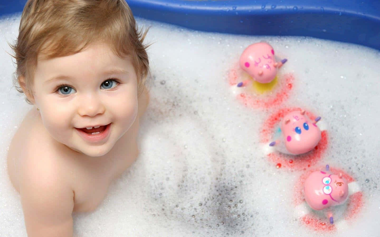 A Baby Is Playing With Bubbles In A Bath Tub