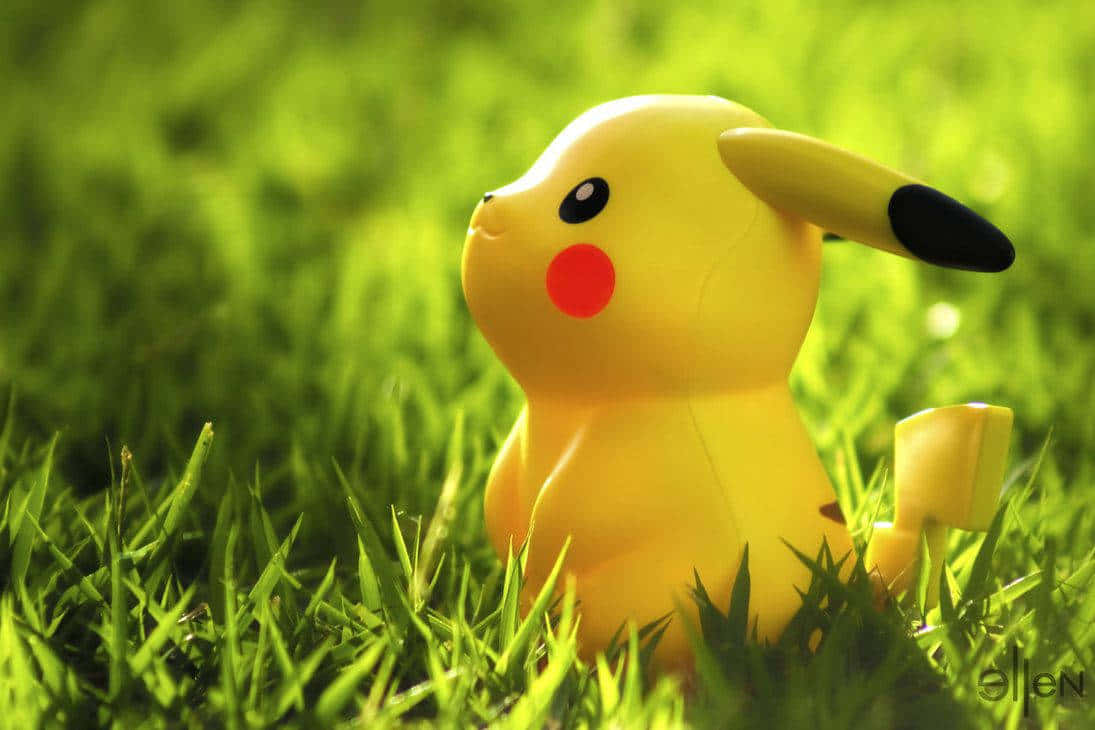 Cute Baby Pikachu Toy In Grass Wallpaper