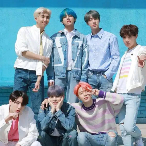 Cute Bts Group Poses Together On A Blue Wall