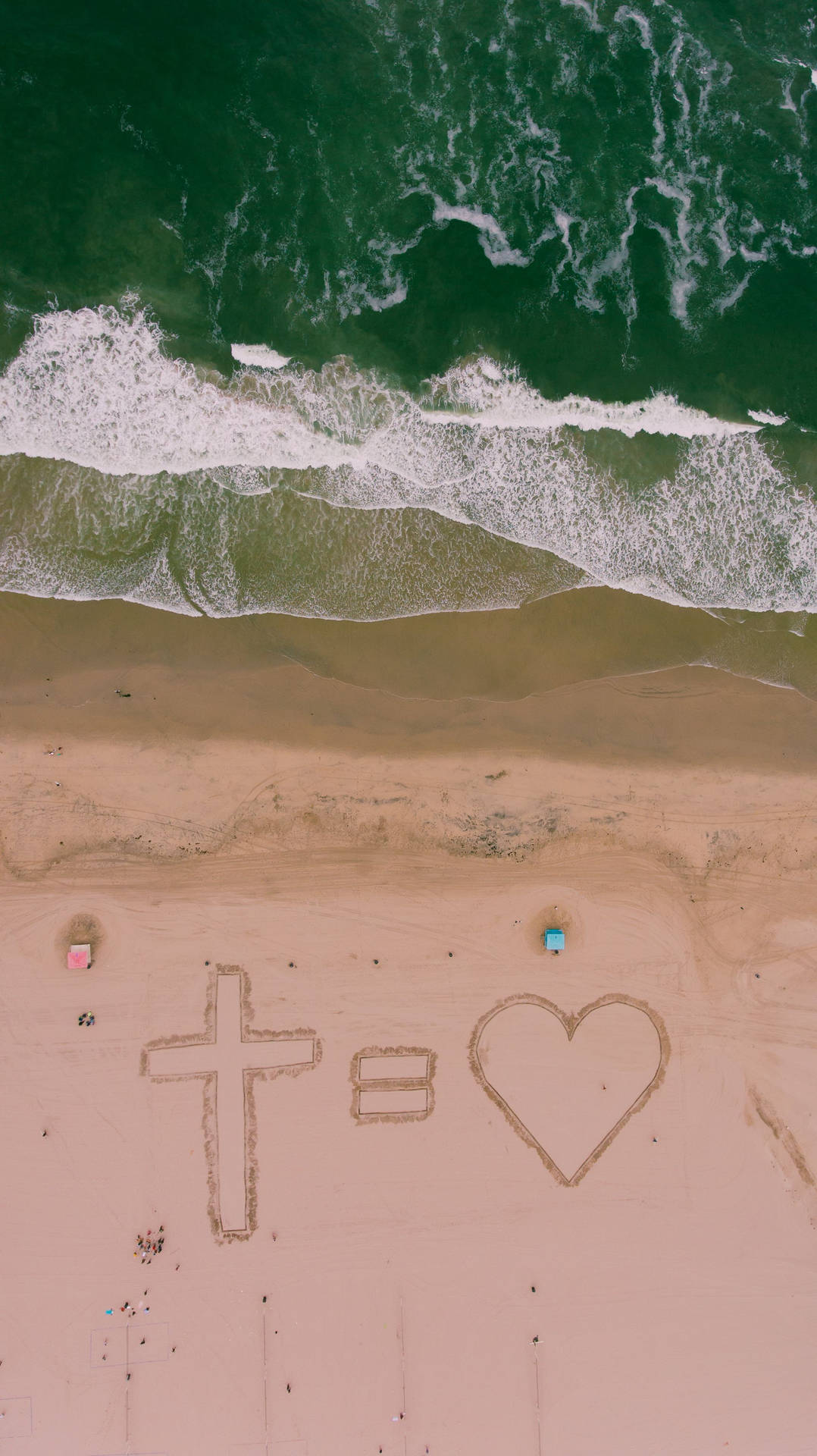 Sötkristen Kors Symboliserar Kärlek På Stranden Wallpaper