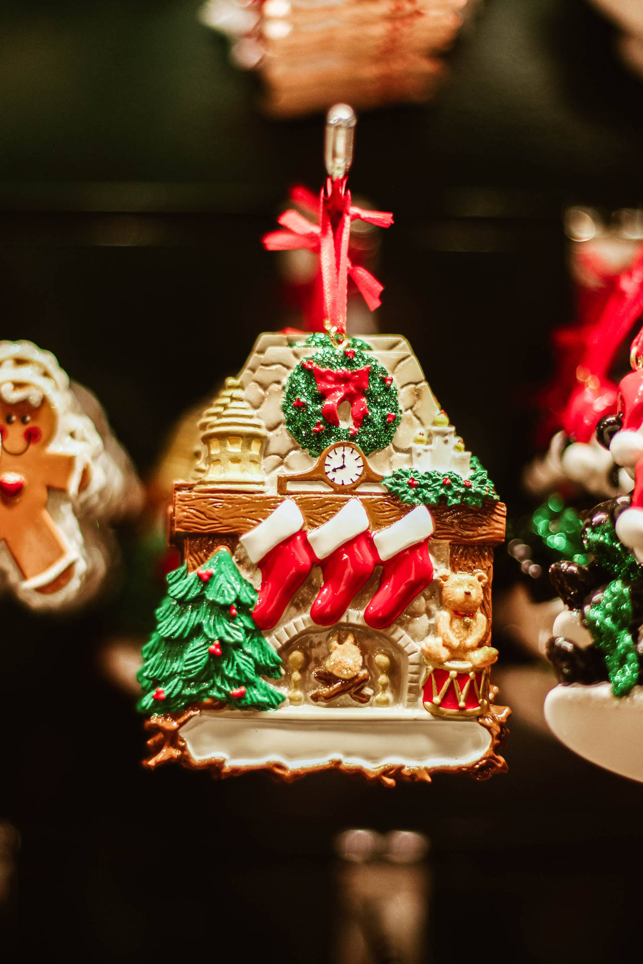 Welcome the holiday season in your home with a festive Gingerbread House Christmas Tree Wallpaper