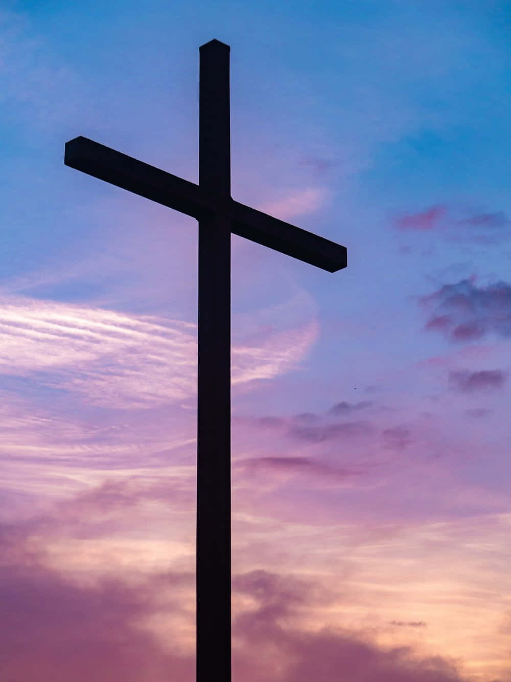 A silhouette of a white Cross on a pink background. Wallpaper