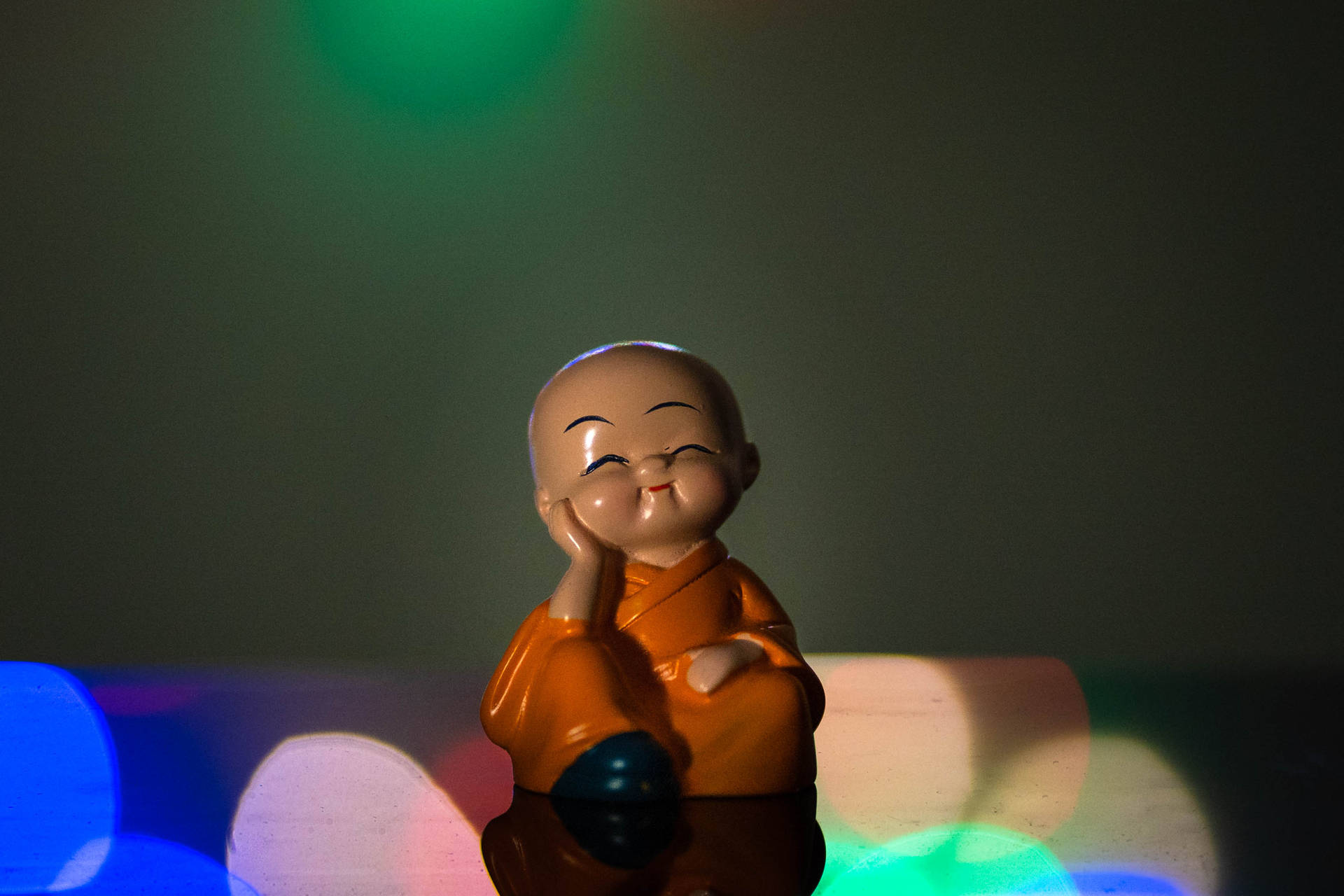 Cute Doll Monk On Table Wallpaper