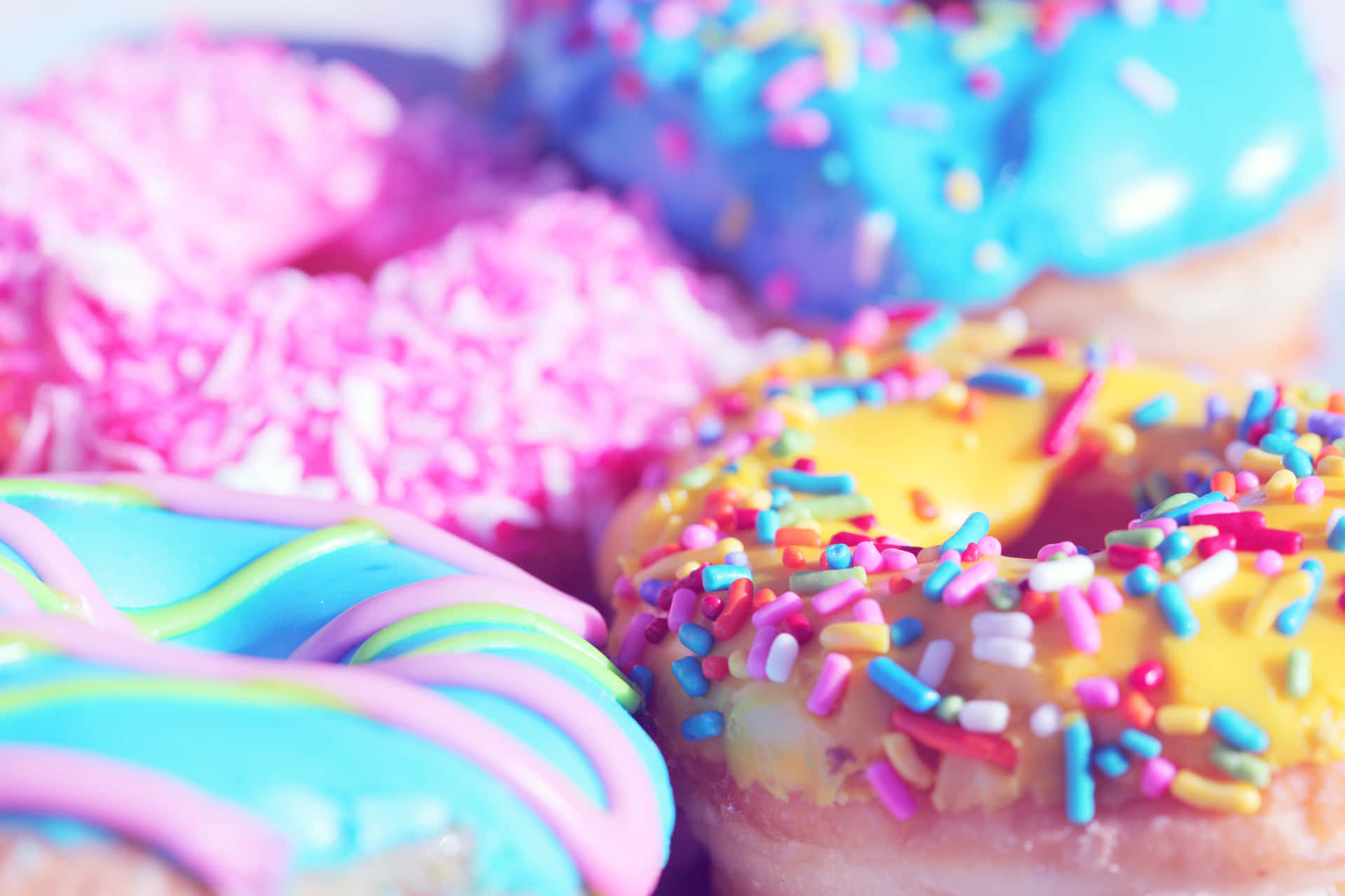 Adorable Pink Glazed Donut with Sprinkles on a Marble Surface Wallpaper