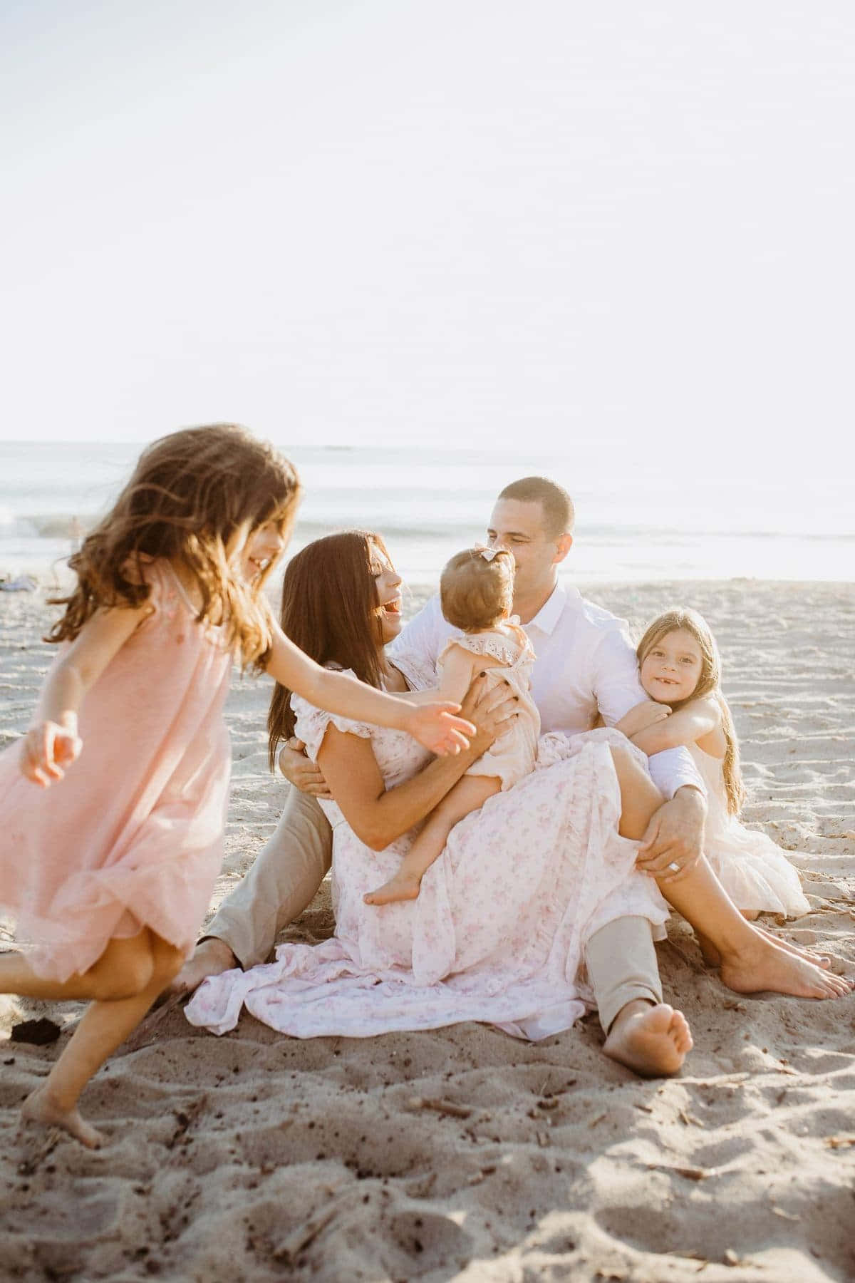 Cute Family Playing Around The Beach Picture