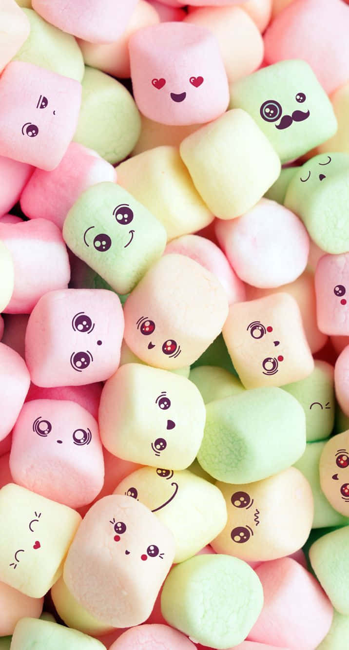 En bunke af marshmallows med ansigter tegnet på dem Wallpaper