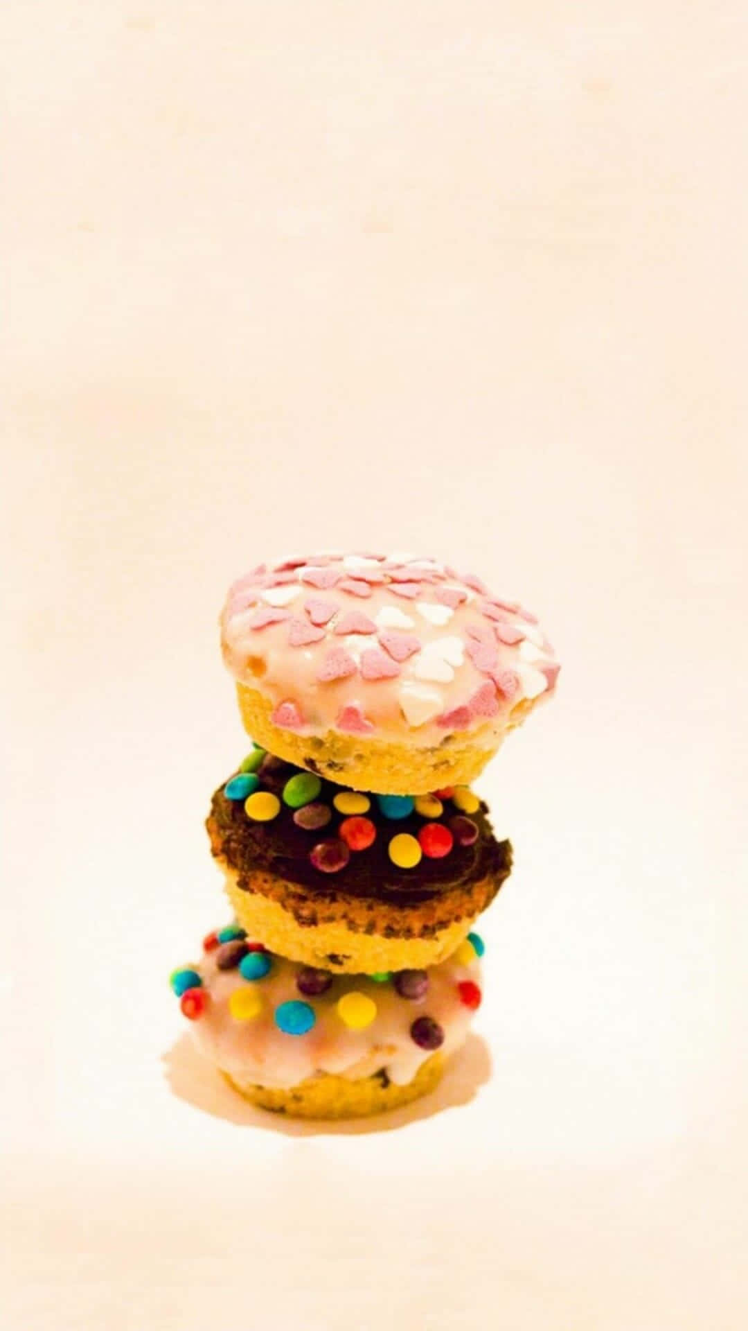 A Stack Of Donuts With Sprinkles On Top Wallpaper