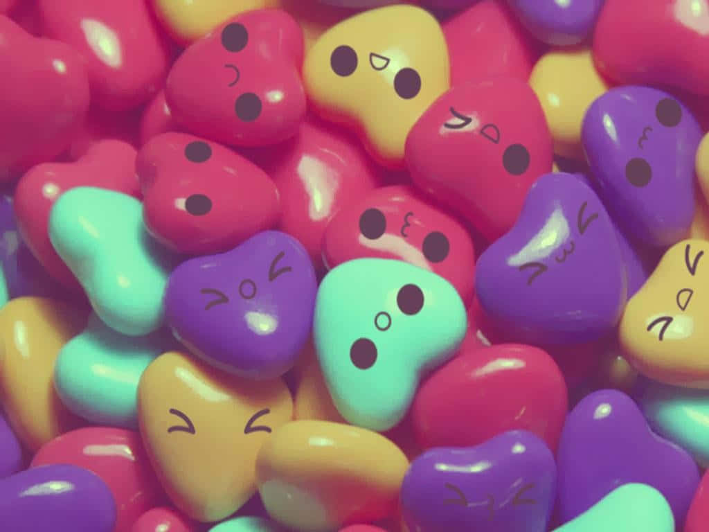 A Pile Of Colorful Candy Hearts With Faces Wallpaper