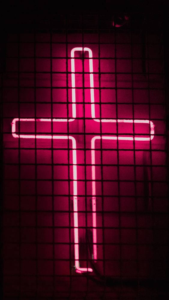 Et neon kors tegnet er tent op i pink. Wallpaper